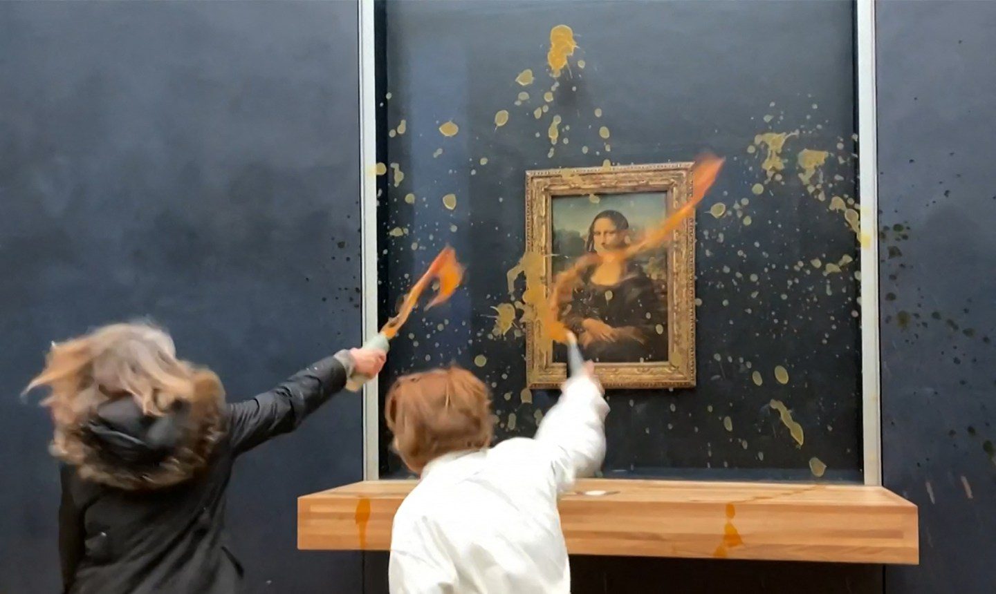 Climate activists splatter Mona Lisa with tomato soup in Louvre Museum